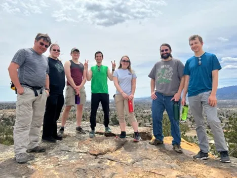 smiling people on top of a bluff