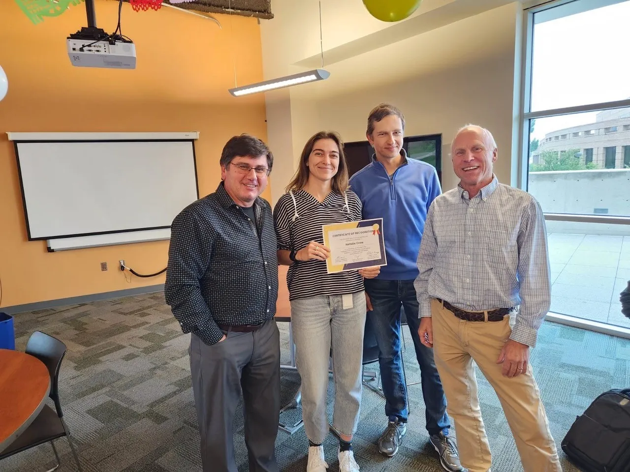 Math clinic participant being awarded a certificate.