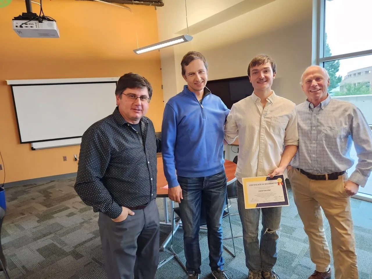 Math clinic participant being awarded a certificate.