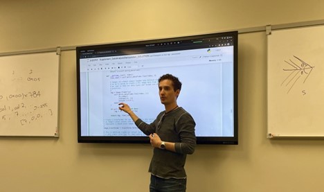 Person teaching at a projection screen
